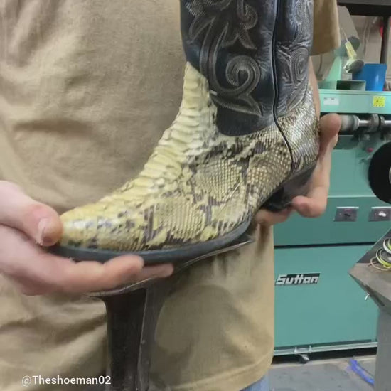 A pair of Vintage Tony Lama lizard skin cowboy boots being repaired with new leather soles at the cowboy boot repair center.