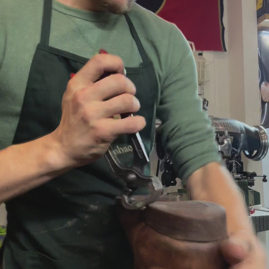 A pair of Redwing Iron Ranger Boots being repaired with new Vibram 100 soles and heels at the Redwing Boot repair center