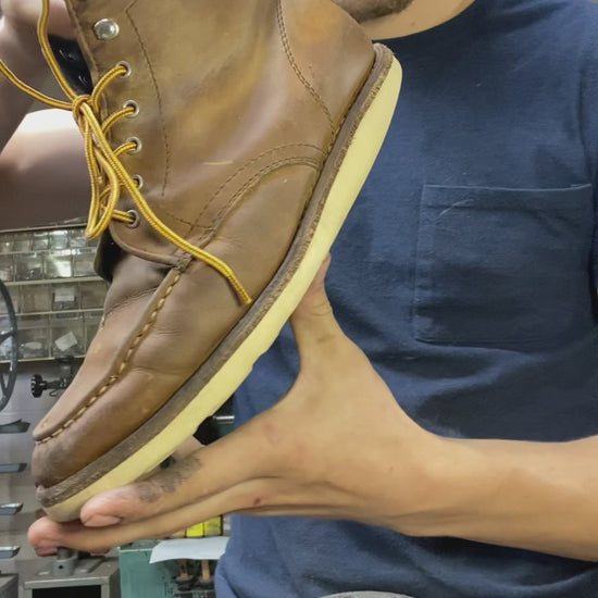 a pair of Thursday Boots being repaired with new Vibram Wedge soles at the boot repair center